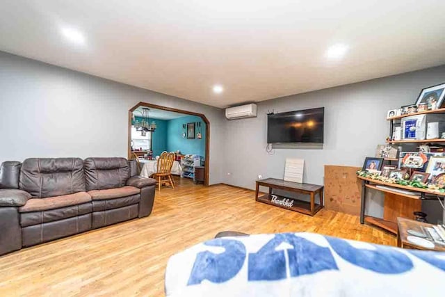 148 Chandler Ln, Montgomery, NY 12549 - living area with arched walkways, recessed lighting, a wall unit AC, and wood finished floors