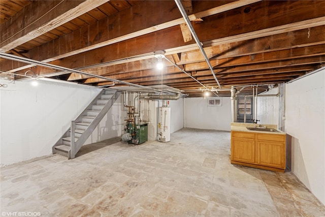 unfinished basement featuring stairs, a heating unit, a sink, and gas water heater