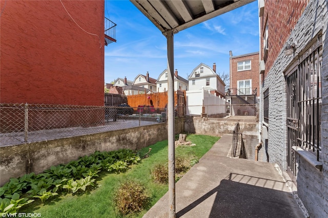 view of patio with a residential view and a fenced backyard