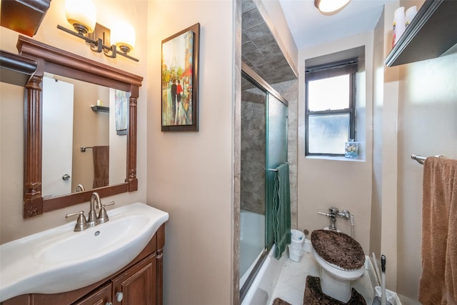 bathroom featuring shower / bath combination with glass door, toilet, and vanity