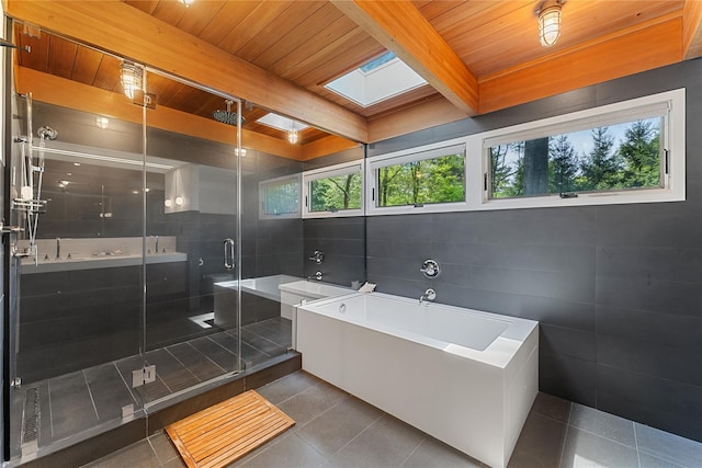 full bath with wood ceiling, a bath, tile patterned floors, a shower stall, and a skylight