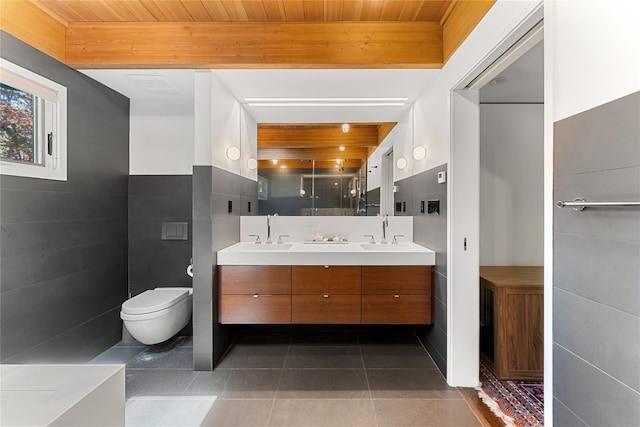 bathroom with a sink, tile patterned flooring, a stall shower, and double vanity