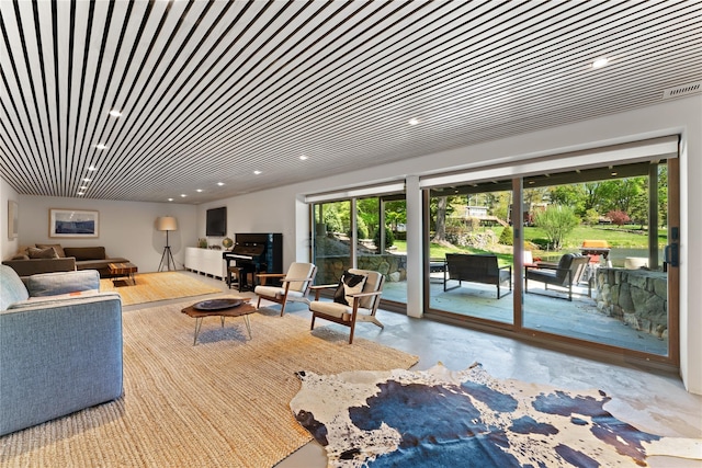 living room with recessed lighting and concrete floors