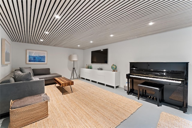 living room featuring concrete flooring and recessed lighting