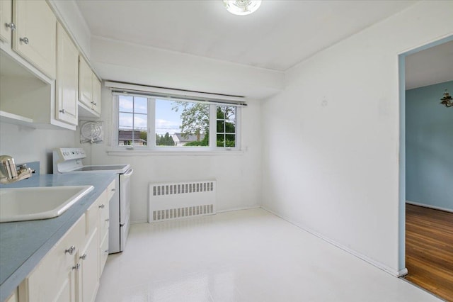clothes washing area with a sink and radiator heating unit