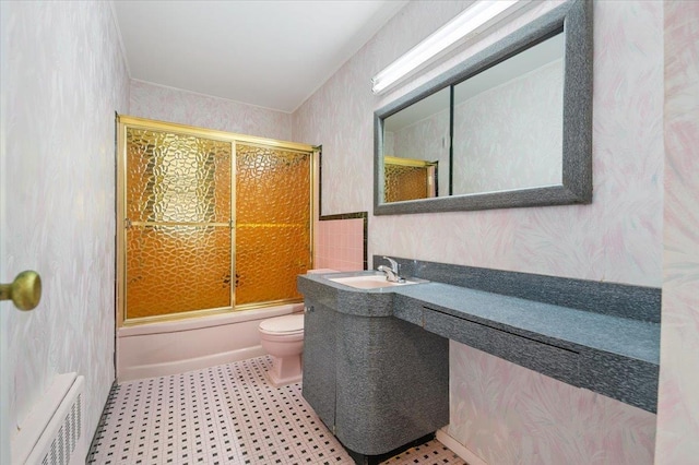 full bathroom featuring wallpapered walls, toilet, radiator, bath / shower combo with glass door, and vanity