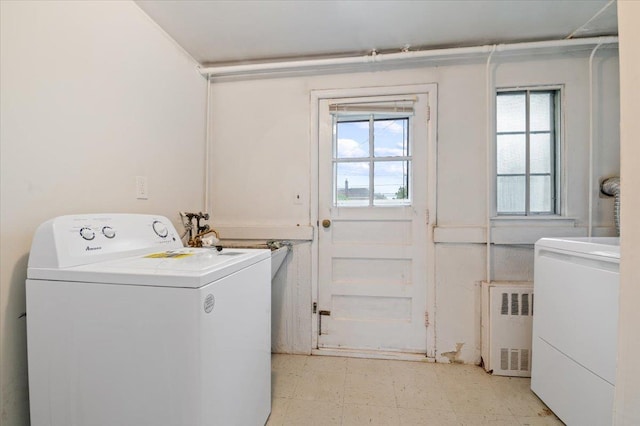 laundry area featuring laundry area, light floors, washer / dryer, and radiator heating unit