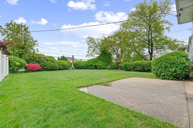 view of yard with fence and a patio