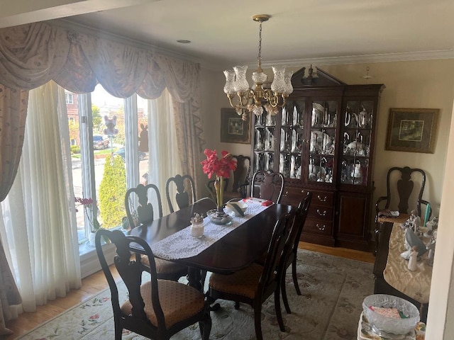 84-08 164th Ave, Howard Beach, NY 11414 - dining room with crown molding, a notable chandelier, wood finished floors, and a healthy amount of sunlight