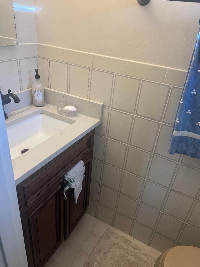 84-08 164th Ave, Howard Beach, NY 11414 - bathroom with tile walls, toilet, tile patterned flooring, and vanity