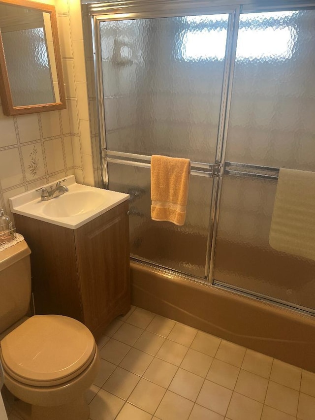 84-08 164th Ave, Howard Beach, NY 11414 - full bathroom featuring vanity, toilet, tile patterned flooring, and shower / bath combination with glass door