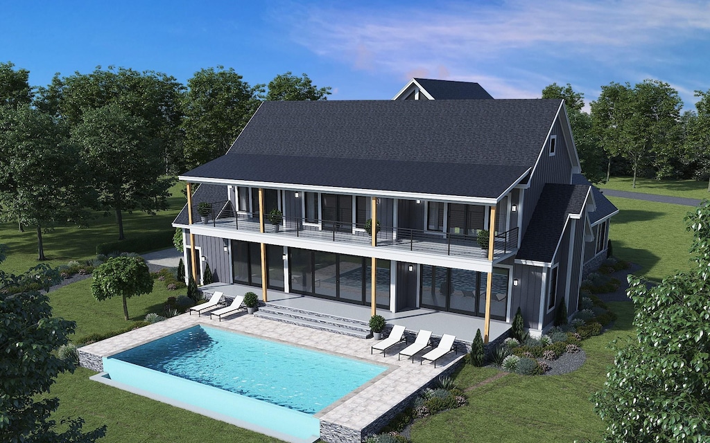 rear view of house featuring a lawn, a patio, a balcony, and an outdoor pool