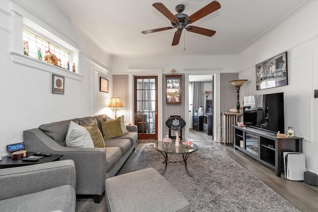 living room with wood finished floors and a ceiling fan