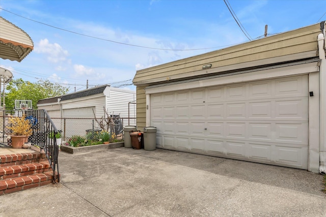 detached garage featuring fence