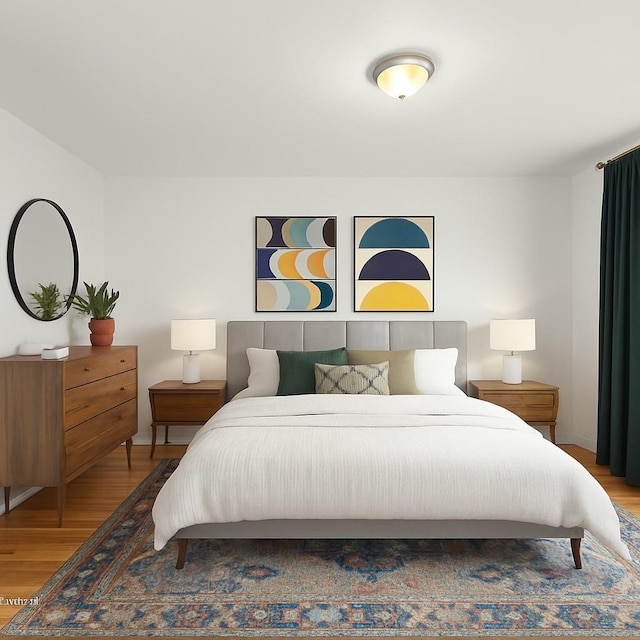 bedroom with baseboards and wood finished floors