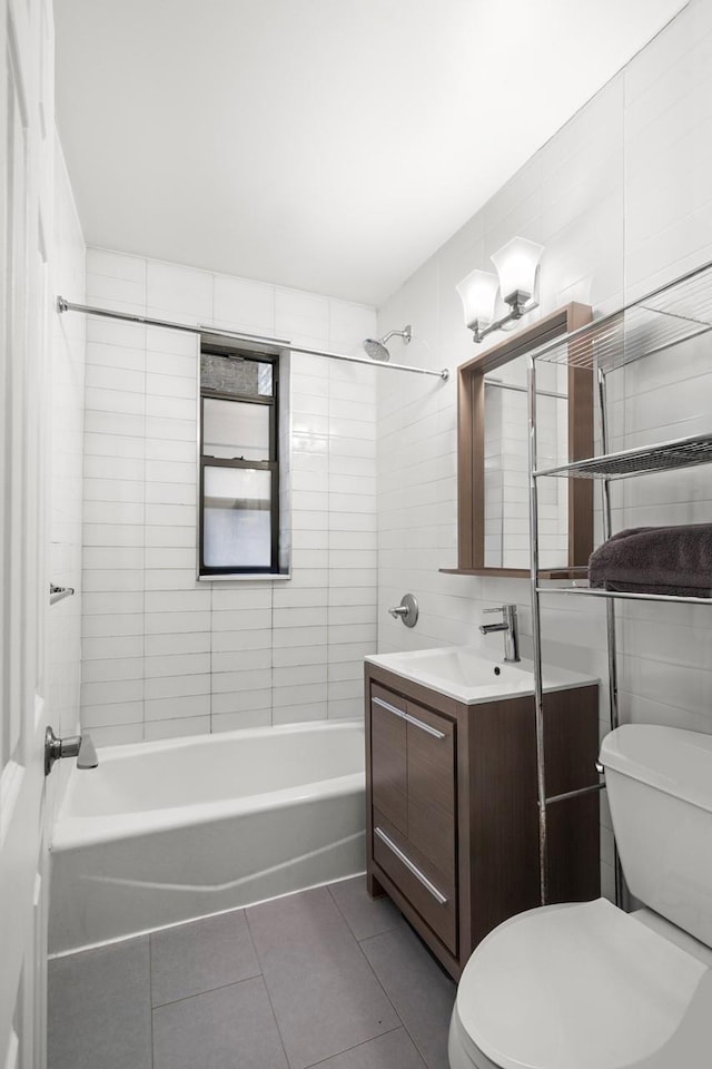 full bath with tile patterned floors, toilet, and tile walls