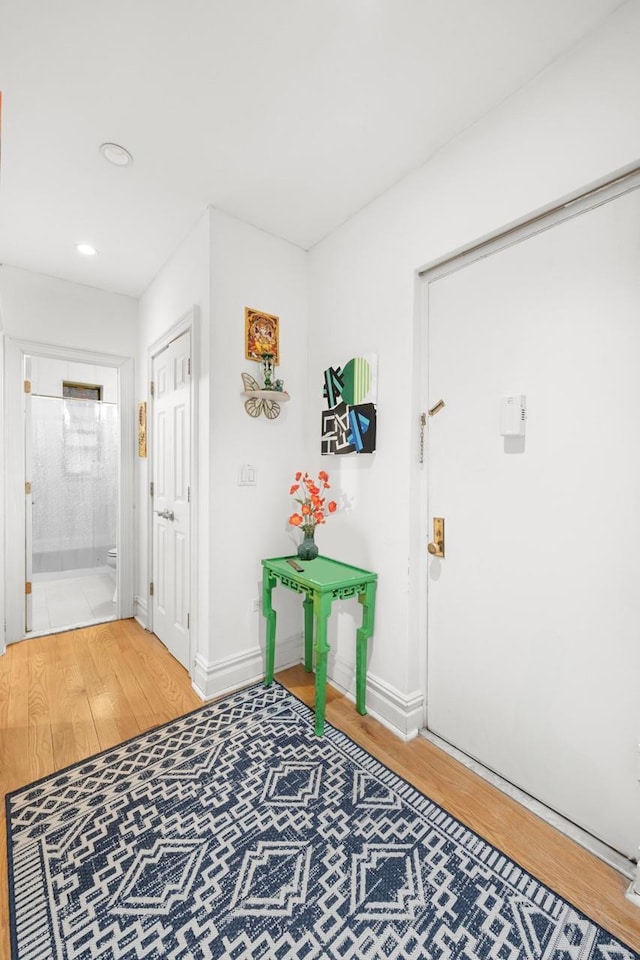 entrance foyer featuring recessed lighting, baseboards, and wood finished floors