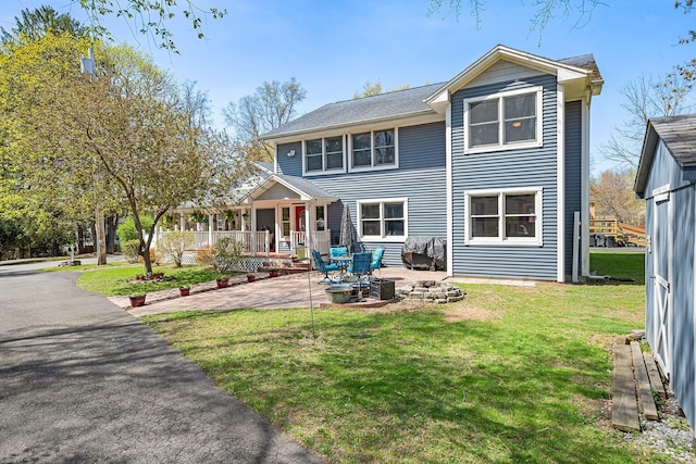 rear view of property with a lawn and a patio area