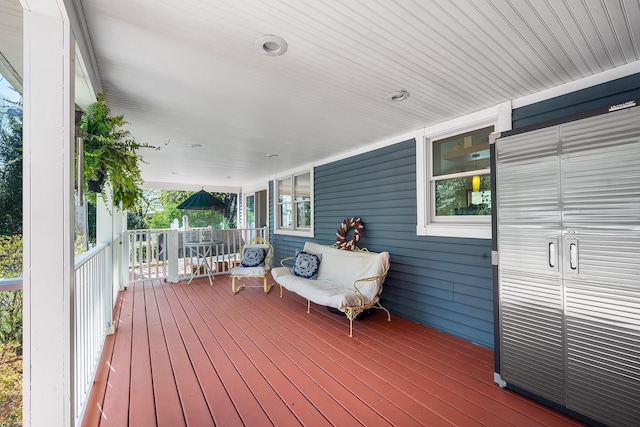 wooden terrace featuring covered porch
