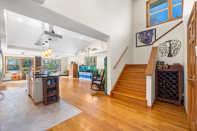 kitchen with dark countertops, ceiling fan, light wood-style floors, recessed lighting, and open floor plan