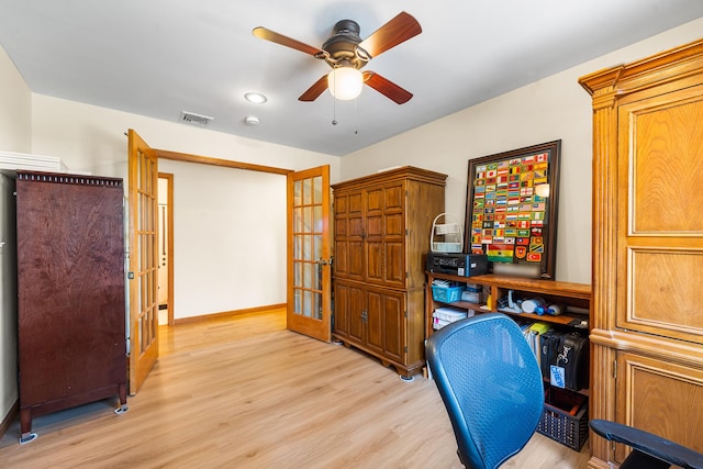office area featuring baseboards, ceiling fan, light wood-type flooring, and visible vents