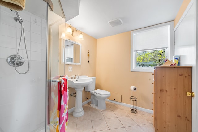 bathroom featuring tile patterned flooring, toilet, baseboards, visible vents, and a stall shower