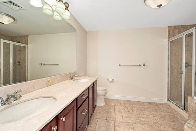 bathroom featuring visible vents, a shower stall, and a sink