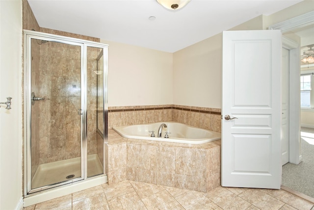bathroom with tile patterned flooring, a shower stall, and a garden tub
