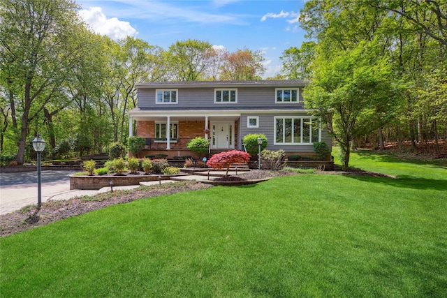 traditional-style house with a front lawn and a porch