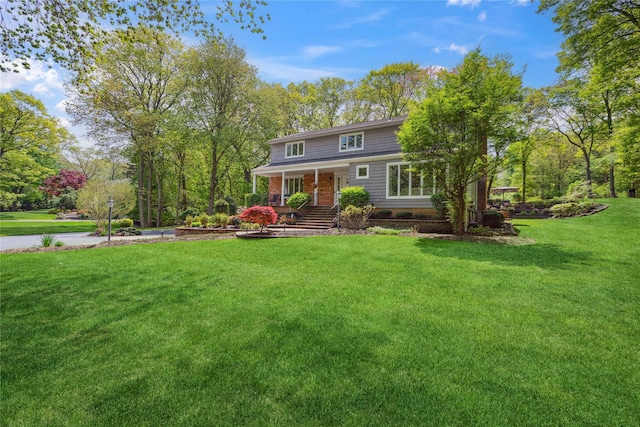 view of front of house featuring a porch and a front yard