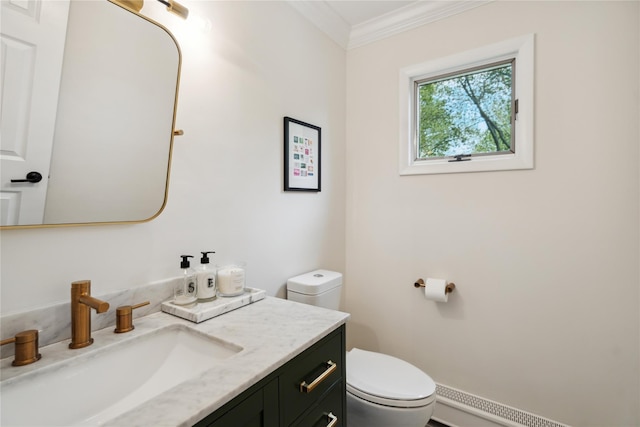 half bathroom with ornamental molding, toilet, vanity, and baseboard heating