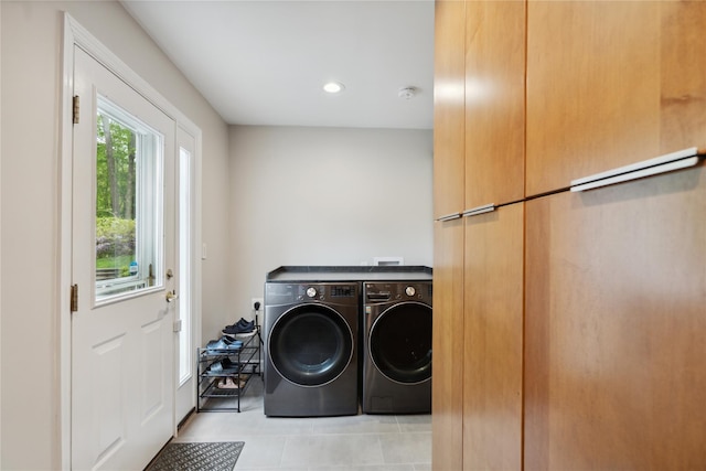laundry room with washing machine and clothes dryer, light tile patterned flooring, and recessed lighting