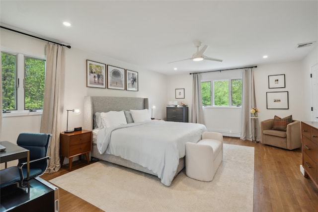 bedroom featuring recessed lighting, a ceiling fan, visible vents, and wood finished floors