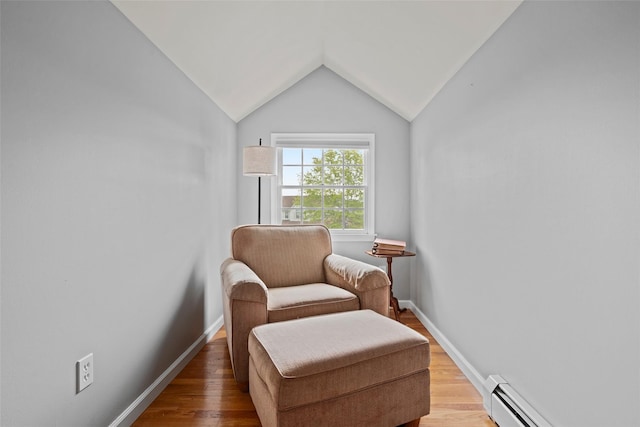 living area with light wood-style floors, baseboards, lofted ceiling, and a baseboard radiator
