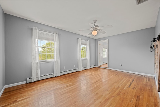 unfurnished room featuring ceiling fan, baseboard heating, baseboards, light wood-type flooring, and visible vents
