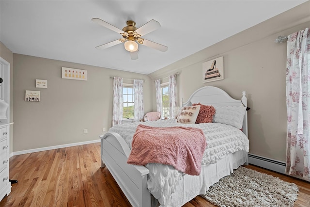 bedroom featuring a ceiling fan, baseboards, and light wood-type flooring