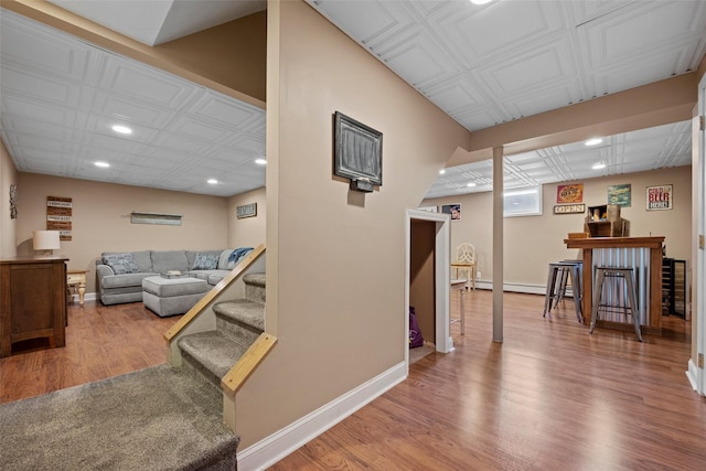 living room with recessed lighting, baseboards, and wood finished floors