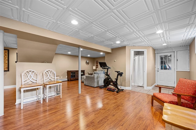 workout room with an ornate ceiling, recessed lighting, baseboards, and light wood-style flooring