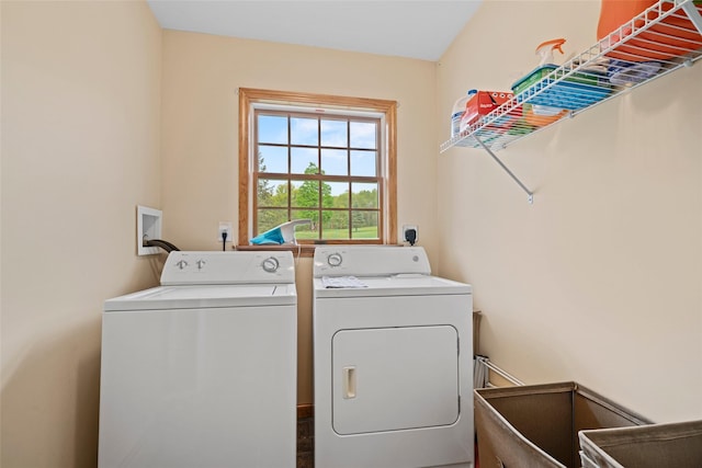 clothes washing area featuring laundry area and washer and clothes dryer