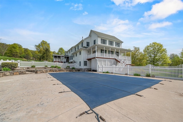 view of pool featuring a fenced in pool, stairway, fence private yard, and a porch