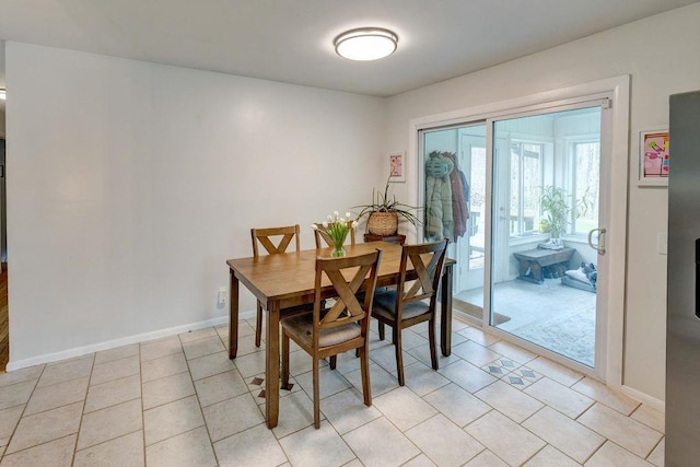 dining space with baseboards and light tile patterned floors