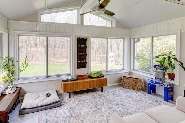 sunroom featuring baseboards and lofted ceiling