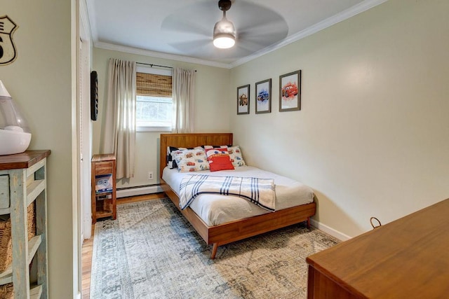 bedroom with light wood finished floors, ceiling fan, ornamental molding, and baseboard heating