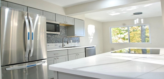 11 Lakeview Ct, Rock Hill, NY 12775 - kitchen featuring a sink, stainless steel appliances, decorative backsplash, gray cabinets, and light stone counters