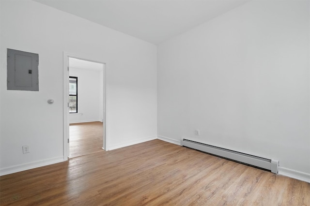 4465 Park Ave, Bronx, NY 10457 - unfurnished room with wood finished floors, electric panel, a baseboard heating unit, and baseboards
