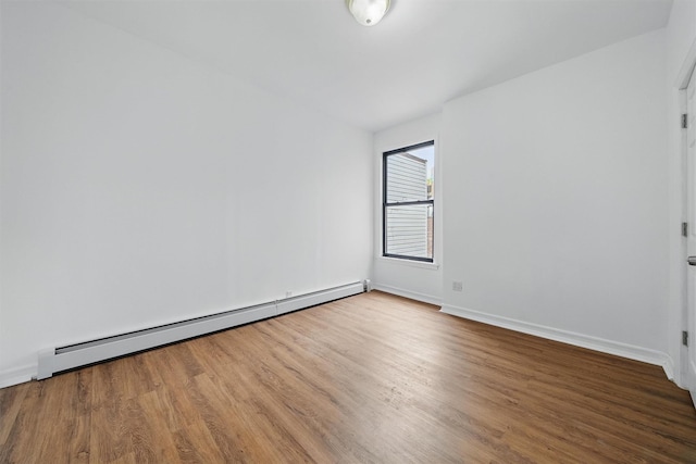 4465 Park Ave, Bronx, NY 10457 - empty room featuring baseboards, wood finished floors, and a baseboard radiator