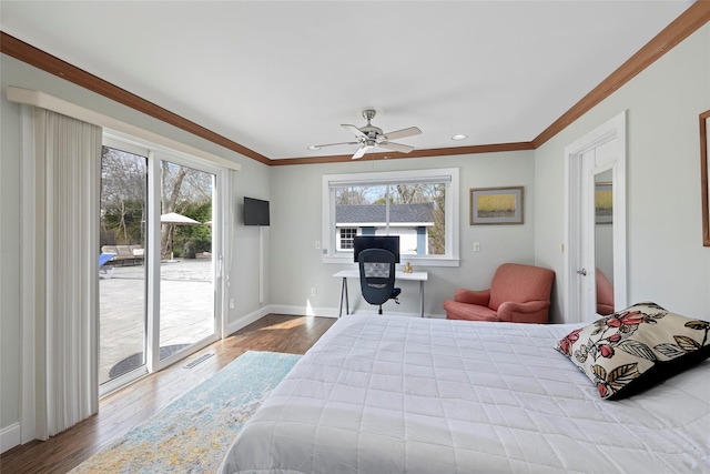 bedroom with visible vents, wood finished floors, access to outside, and multiple windows