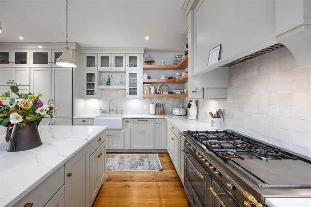 3585 Rte 82, Millbrook, NY 12545 - kitchen featuring a sink, open shelves, hanging light fixtures, backsplash, and light wood-type flooring