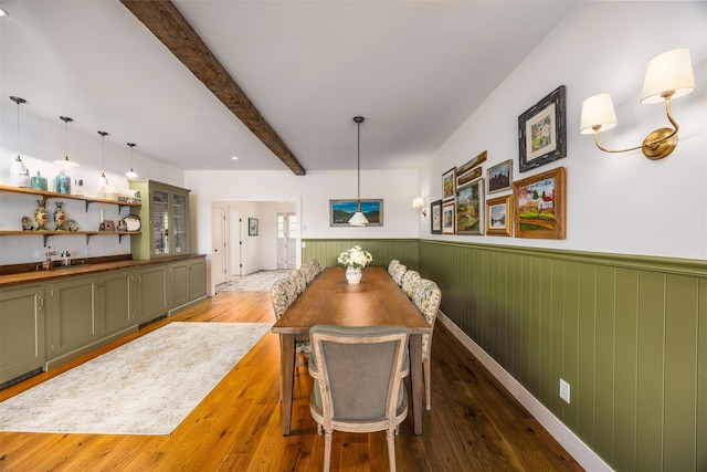 3585 Rte 82, Millbrook, NY 12545 - dining area with a wainscoted wall, hardwood / wood-style floors, beamed ceiling, and bar