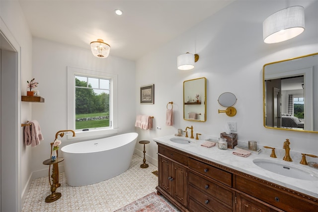 3585 Rte 82, Millbrook, NY 12545 - ensuite bathroom featuring baseboards, double vanity, and a freestanding tub
